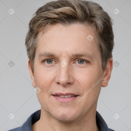 Joyful white adult male with short  brown hair and grey eyes