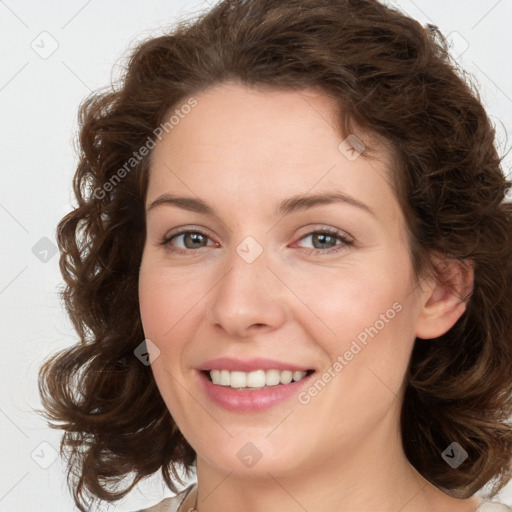 Joyful white young-adult female with medium  brown hair and green eyes