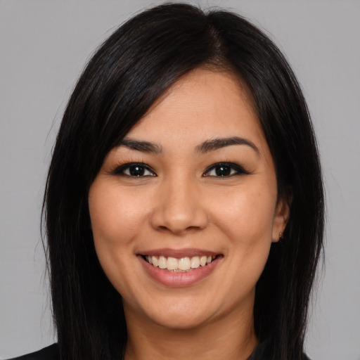 Joyful white young-adult female with long  black hair and brown eyes