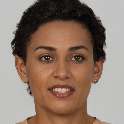 Joyful latino young-adult female with short  brown hair and brown eyes