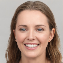 Joyful white young-adult female with long  brown hair and grey eyes