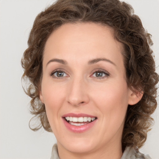 Joyful white young-adult female with medium  brown hair and green eyes