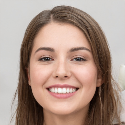 Joyful white young-adult female with long  brown hair and grey eyes