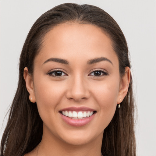 Joyful white young-adult female with long  brown hair and brown eyes