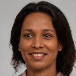 Joyful white adult female with medium  brown hair and brown eyes