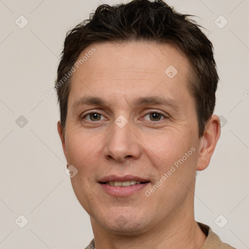 Joyful white adult male with short  brown hair and grey eyes