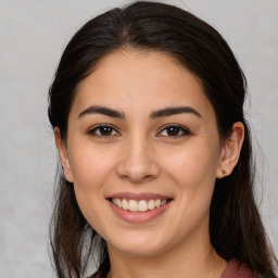 Joyful white young-adult female with long  brown hair and brown eyes