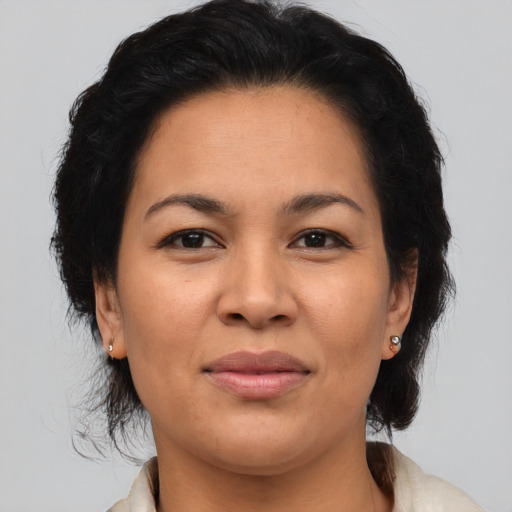 Joyful asian adult female with medium  brown hair and brown eyes