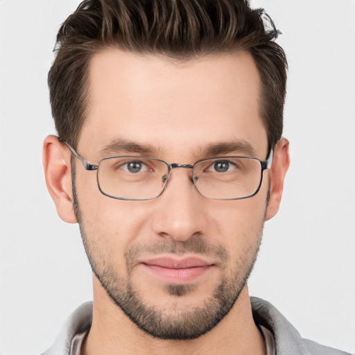 Joyful white young-adult male with short  brown hair and brown eyes