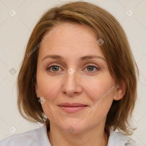 Joyful white adult female with medium  brown hair and blue eyes