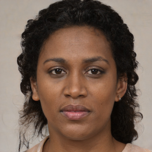 Neutral black young-adult female with medium  brown hair and brown eyes