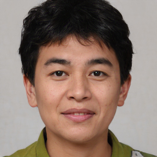 Joyful asian young-adult male with short  brown hair and brown eyes