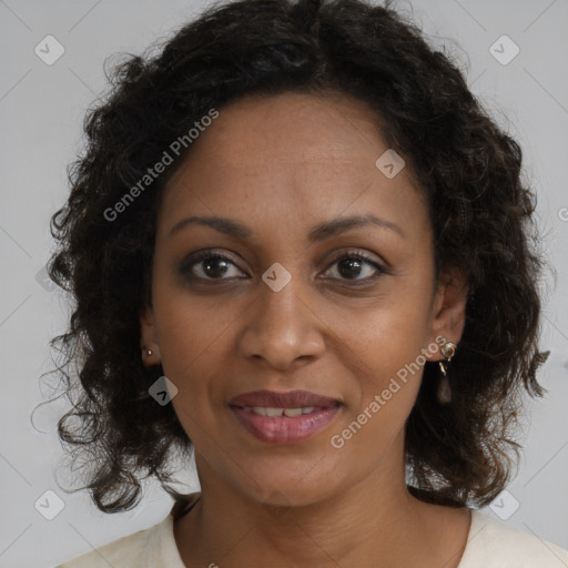 Joyful black adult female with medium  brown hair and brown eyes