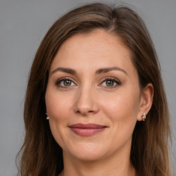 Joyful white adult female with long  brown hair and brown eyes