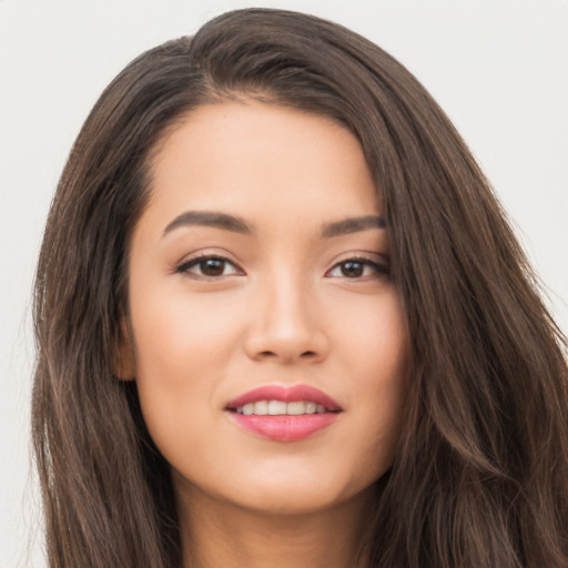 Joyful asian young-adult female with long  brown hair and brown eyes