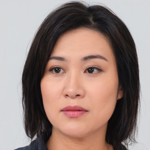 Neutral asian young-adult female with medium  brown hair and brown eyes