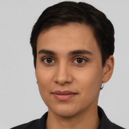 Joyful latino young-adult male with short  brown hair and brown eyes