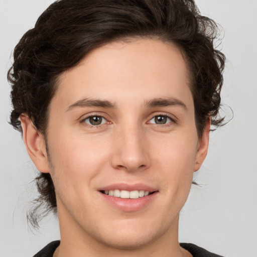 Joyful white young-adult male with medium  brown hair and brown eyes