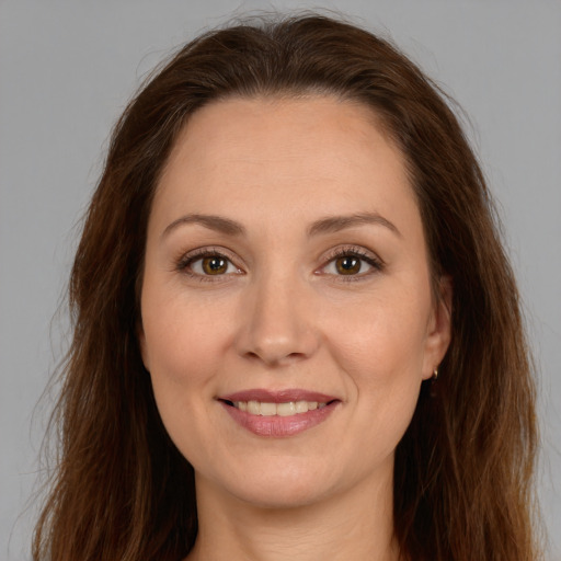 Joyful white young-adult female with long  brown hair and brown eyes