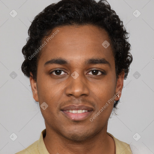 Joyful black young-adult male with short  brown hair and brown eyes