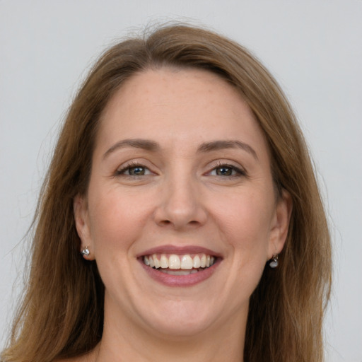 Joyful white young-adult female with long  brown hair and grey eyes