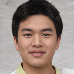 Joyful asian young-adult male with short  brown hair and brown eyes