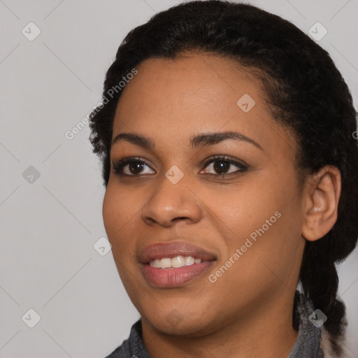 Joyful black young-adult female with short  black hair and brown eyes