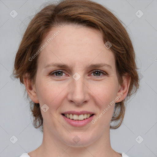 Joyful white adult female with medium  brown hair and grey eyes