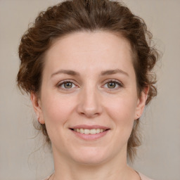 Joyful white young-adult female with medium  brown hair and green eyes