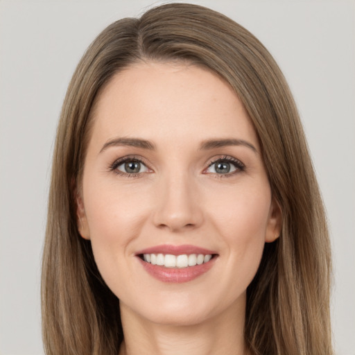 Joyful white young-adult female with long  brown hair and brown eyes