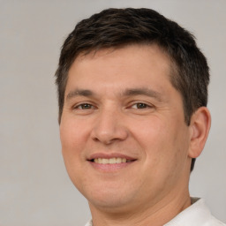 Joyful white adult male with short  brown hair and brown eyes