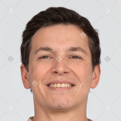 Joyful white adult male with short  brown hair and brown eyes