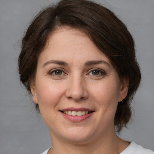 Joyful white young-adult female with medium  brown hair and brown eyes