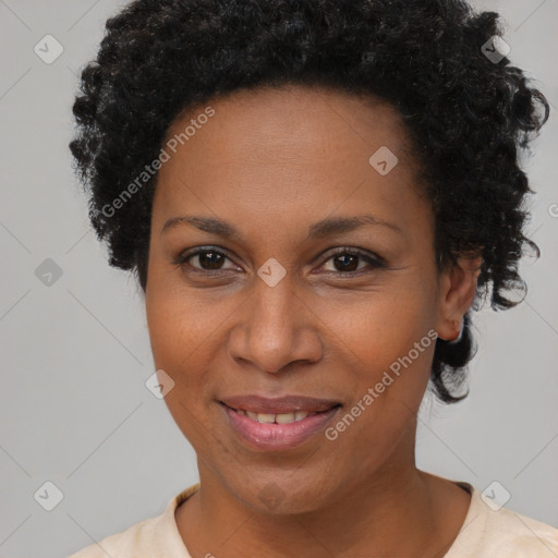 Joyful black adult female with short  brown hair and brown eyes