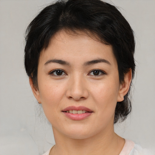 Joyful asian young-adult female with medium  brown hair and brown eyes