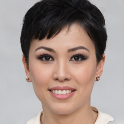 Joyful asian young-adult female with short  black hair and brown eyes