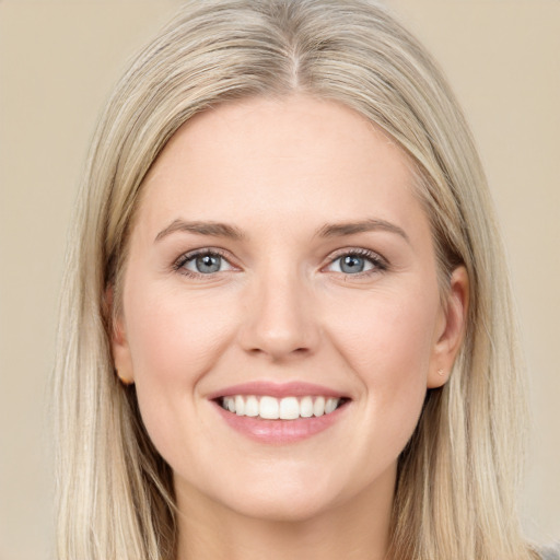 Joyful white young-adult female with long  brown hair and blue eyes