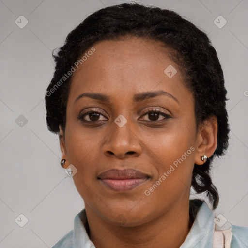 Joyful black adult female with long  brown hair and brown eyes