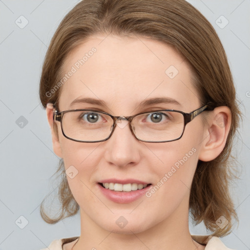 Joyful white young-adult female with medium  brown hair and grey eyes