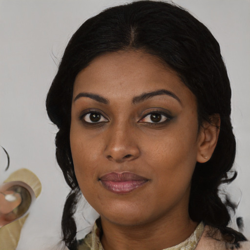 Joyful black young-adult female with medium  black hair and brown eyes
