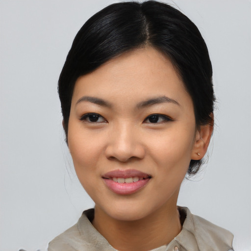 Joyful asian young-adult female with medium  black hair and brown eyes