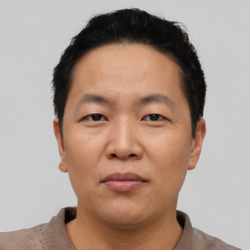 Neutral asian adult male with short  black hair and brown eyes