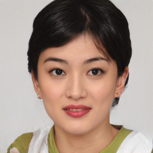 Joyful asian young-adult female with medium  black hair and brown eyes