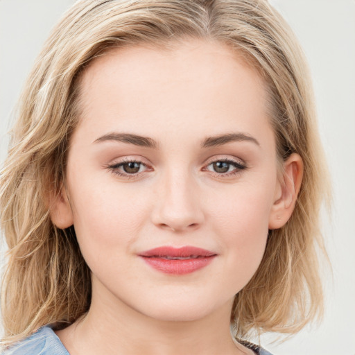 Joyful white young-adult female with long  brown hair and blue eyes