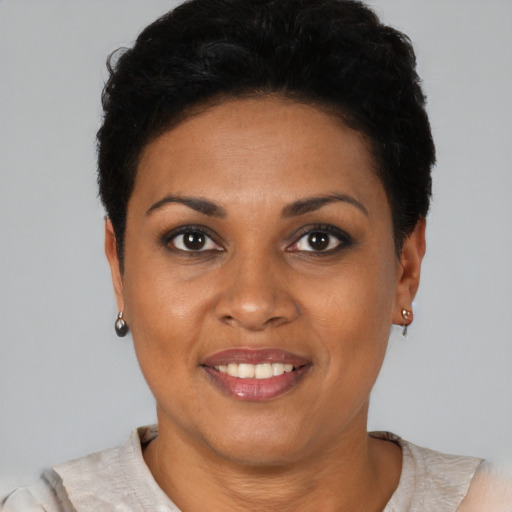 Joyful black young-adult female with short  brown hair and brown eyes