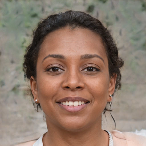 Joyful latino young-adult female with short  brown hair and brown eyes