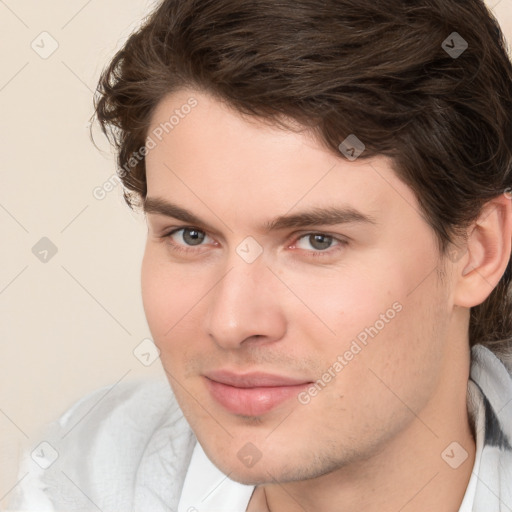 Joyful white young-adult male with medium  brown hair and brown eyes