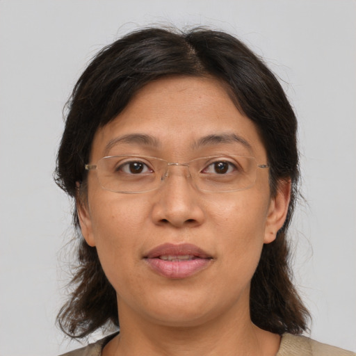 Joyful asian adult female with medium  brown hair and brown eyes