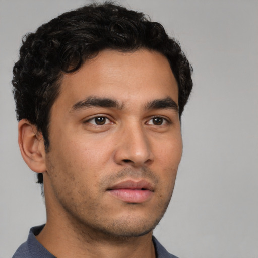 Neutral latino young-adult male with short  brown hair and brown eyes