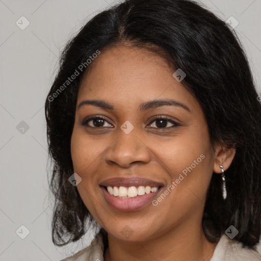 Joyful black young-adult female with long  brown hair and brown eyes